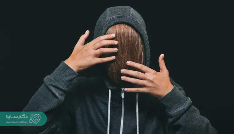 A girl with bipolar Bipolar II disorder wearing a hoodie with her hair in her face