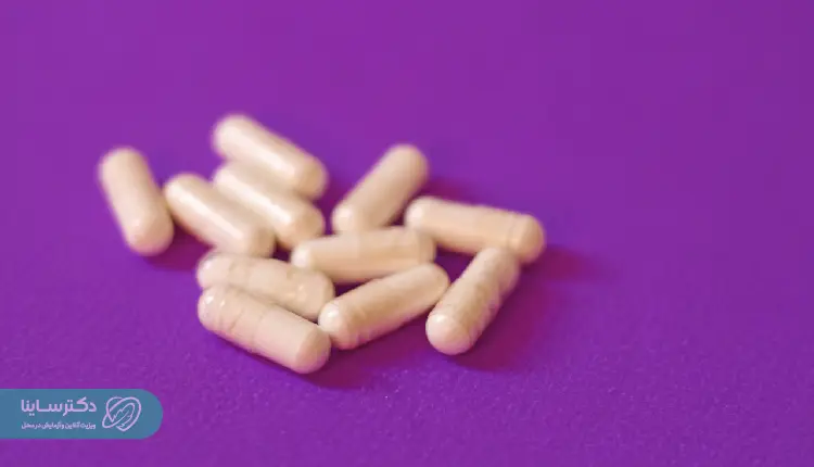 Iron supplement capsules on a purple background, often recommended for patients with low hemoglobin levels identified through the MCH test