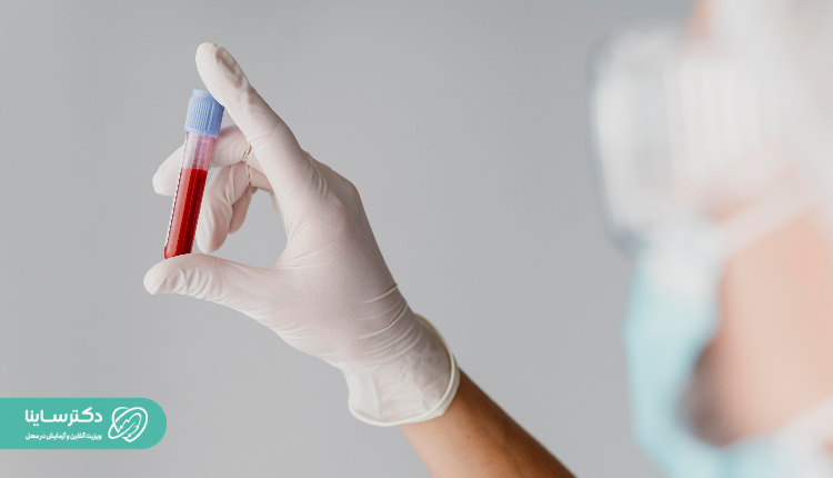 A gloved hand holding a blood-filled test tube, ready for CBC blood test processing.