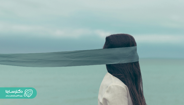 Woman with a scarf covering her eyes, symbolizing mental blindness or confusion. Schizophrenia symptoms treatment metaphor.