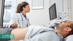 alt="Doctor performing abdominal ultrasound scan on a male patient - What is ultrasound imaging in gastrointestinal health?